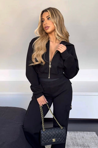 INTIMISSY Studio Plush Crop Jacket in Caviar – women’s black plush cropped jacket with gold zip, matching cargo pants streetwear set