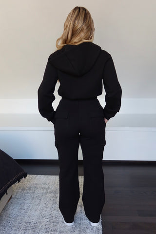 Back view of INTIMISSY Studio Plush Cargo Pants in Caviar Black with soft plush texture and straight-leg silhouette