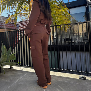 Back view of INTIMISSY Studio Plush cargo pants in Espresso featuring soft plush texture and relaxed silhouette